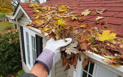 Plumber cleaning a gutter