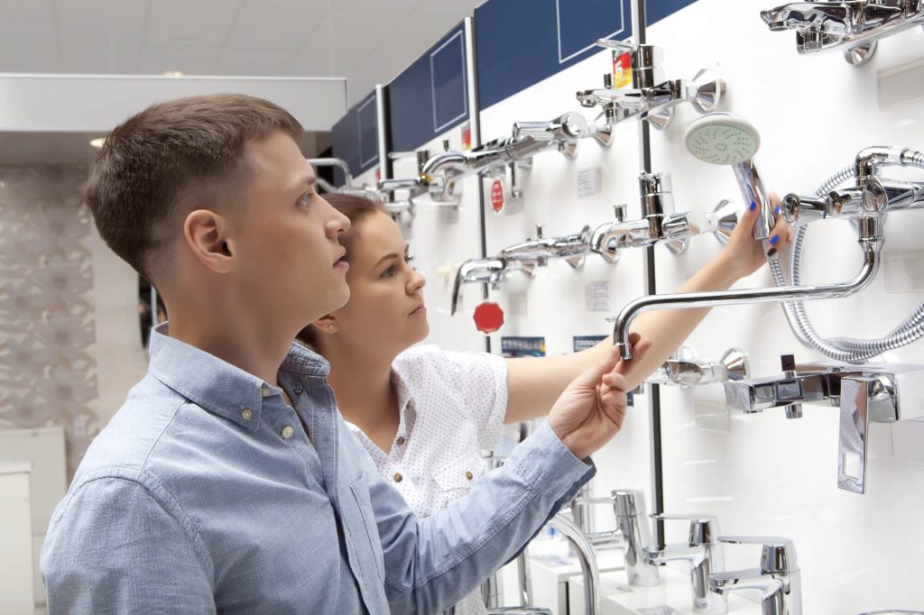 Couple shopping for bathroom equipment in hardware store